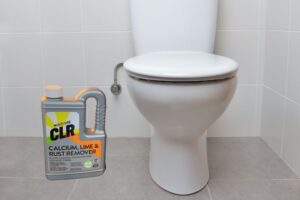 Using CLR on a toilet bowl.
