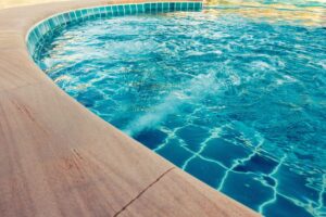 How to Get Sand Out of a Pool (And 6 Reasons Why It’s There)