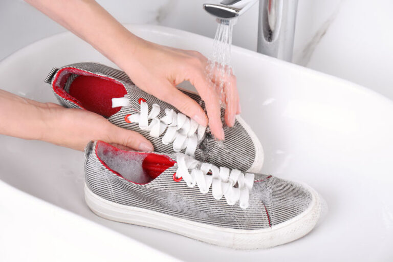 Washing sport shoes in a sink.